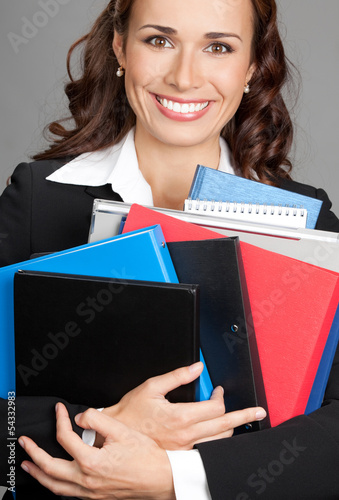 Photo: Businesswoman with folders, on gray Businesswoman with folders, on gray