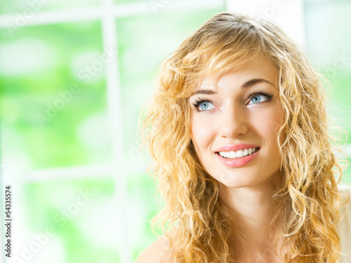 Photo: Smiling young beautiful woman, indoors Smiling young beautiful woman, indoors