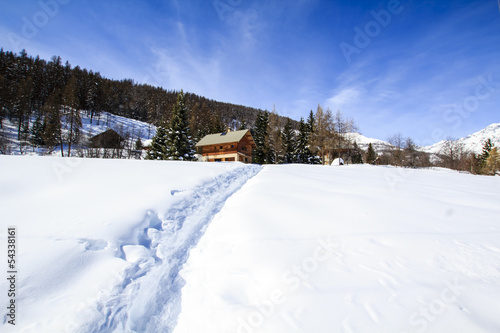 Photo: Way made in snow towards wooden chalet in Alps Way made in snow towards wooden chalet in Alps