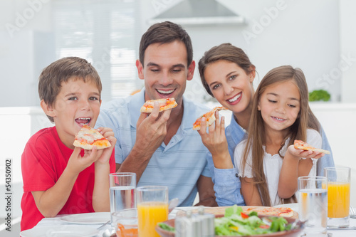 Photo: Family eating pizza slices Family eating pizza slices