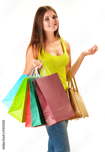 Photo: Young happy woman with colorful paper shopping bags isolated Young happy woman with colorful paper shopping bags isolated