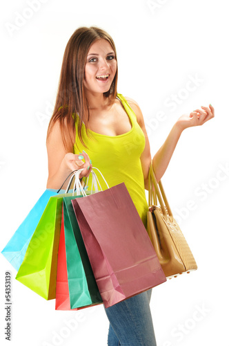 Photo: Young happy woman with colorful paper shopping bags isolated Young happy woman with colorful paper shopping bags isolated