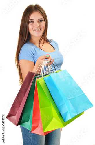 Photo: Young happy woman with colorful paper shopping bags isolated Young happy woman with colorful paper shopping bags isolated