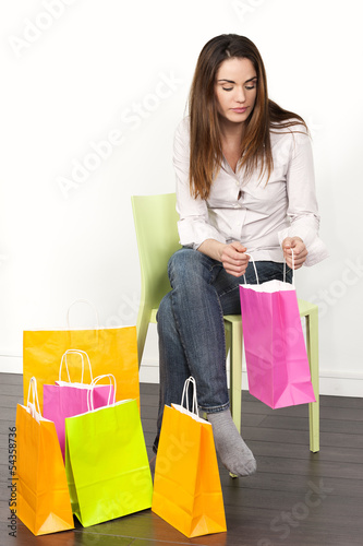 Photo: woman with shopping bags at home woman with shopping bags at home