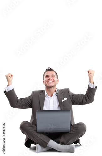 Photo: Business man celebrating his success with a computer laptop Business man celebrating his success with a computer laptop
