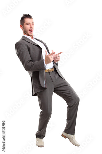 Photo: Young surprised business man pointing at something interesting Young surprised business man pointing at something interesting