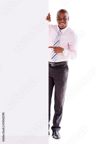 Photo: Business man pointing at a banner Business man pointing at a banner