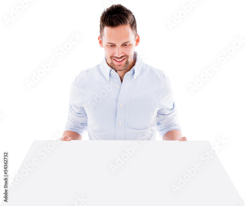 Photo: Man holding a mockup Man holding a mockup