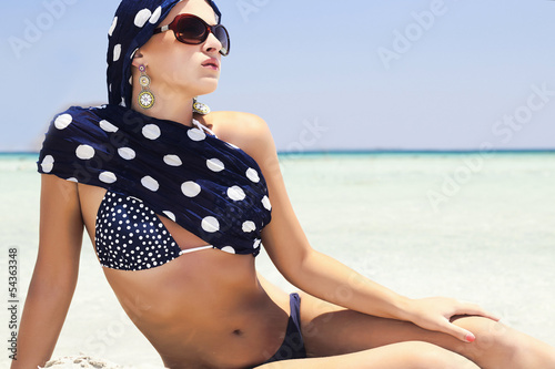 Photo: beautiful woman in blue shawl on beach.your text here beautiful woman in blue shawl on beach.your text here