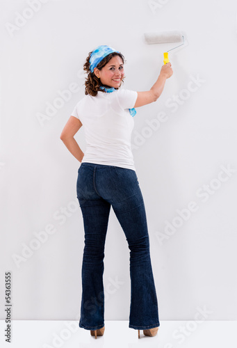 Photo: Woman painting the wall Woman painting the wall