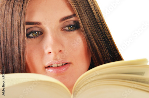 Photo: Young woman reading a book. Female student learning Young woman reading a book. Female student learning