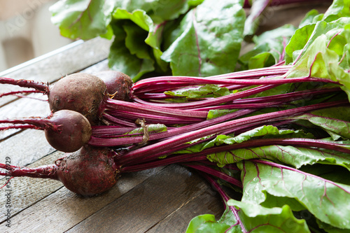 Photo: bunch of fresh beets with leaves on the boards bunch of fresh beets with leaves on the boards