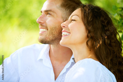 Photo: Happy Smiling Couple Relaxing in a Park. Picnic Happy Smiling Couple Relaxing in a Park. Picnic