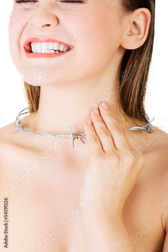 Photo: Throat pain concept. Young woman with barbed wire around her thr Throat pain concept. Young woman with barbed wire around her thr