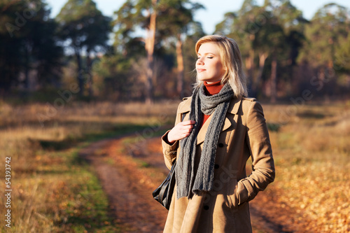 Photo: Blond woman against an autumn nature landscape Blond woman against an autumn nature landscape