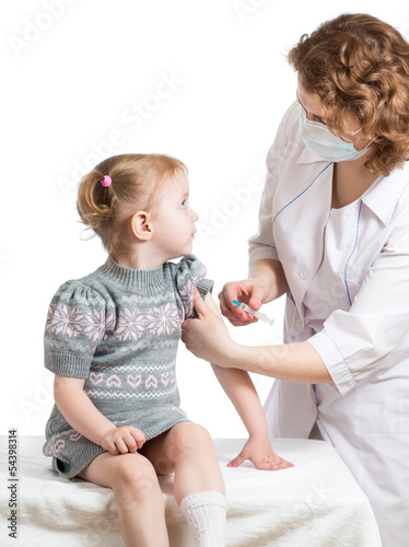 Photo: doctor injecting or vaccinating child isolated on a white doctor injecting or vaccinating child isolated on a white