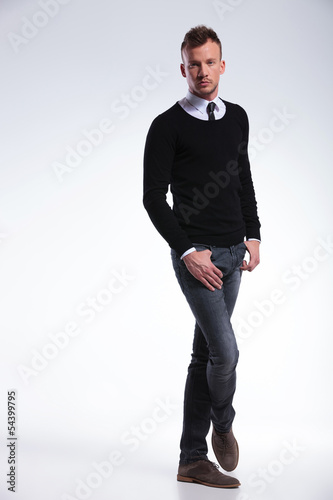 Photo: casual man holds thumbs in pockets casual man holds thumbs in pockets