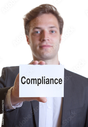 Photo: Mann im Anzug mit Karte COMPLIANCE Mann im Anzug mit Karte COMPLIANCE