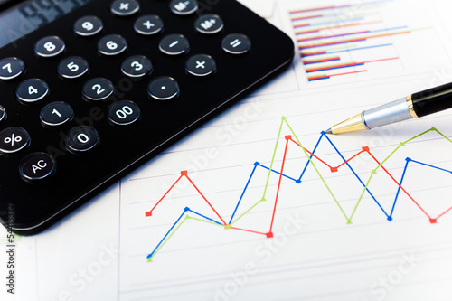Photo: Calculator and financial charts Calculator and financial charts