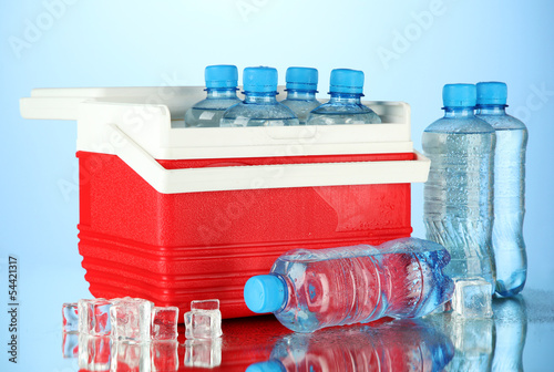 Photo: Traveling refrigerator with bottles of water and ice cubes, Traveling refrigerator with bottles of water and ice cubes,