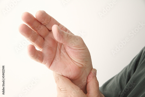 Photo: older man checks pulse older man checks pulse