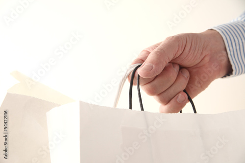 Photo: man holds shopping bags man holds shopping bags