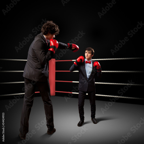 Photo: Two young businessman boxing Two young businessman boxing