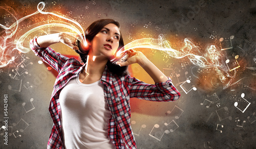 Photo: Young girl listens to music Young girl listens to music