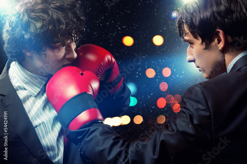 Photo: Two young businessman boxing Two young businessman boxing