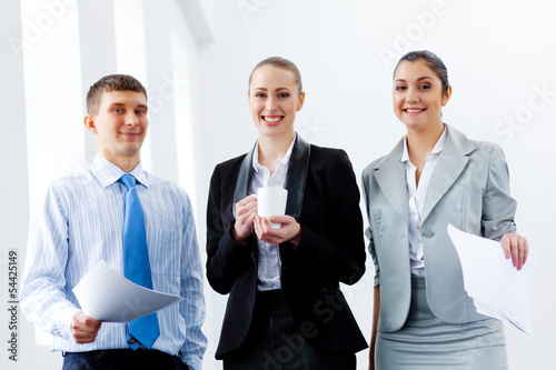 Photo: Three young business people laughing Three young business people laughing