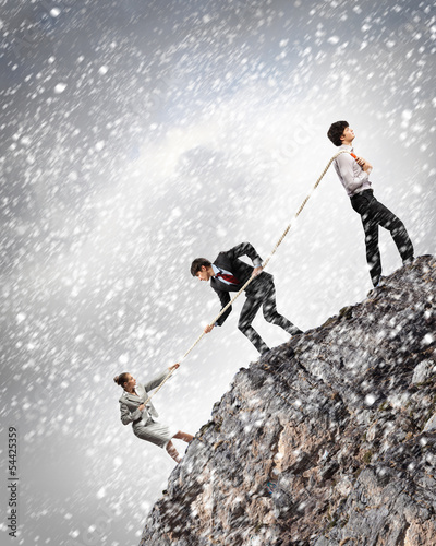 Photo: Three business people pulling rope Three business people pulling rope