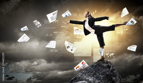 Photo: businesswoman standing atop of mountain businesswoman standing atop of mountain
