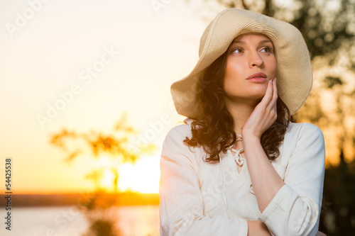 Photo: Romantic girl on the beach during sunset Romantic girl on the beach during sunset