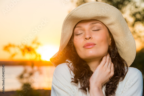 Photo: Romantic girl on the beach during sunset Romantic girl on the beach during sunset