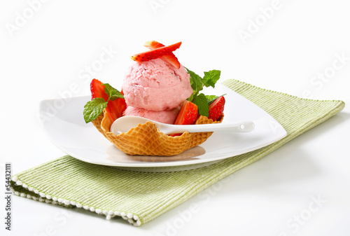 Photo: Ice cream and strawberries in waffle basket Ice cream and strawberries in waffle basket