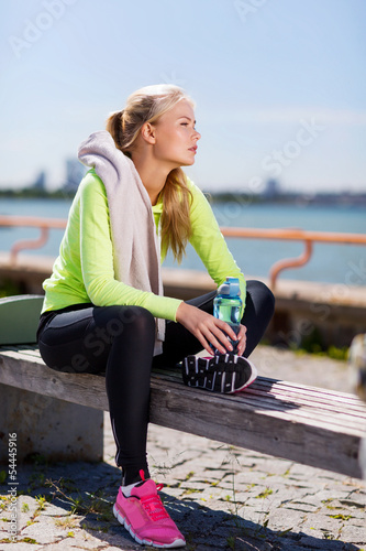 Photo: woman resting after doing sports outdoors woman resting after doing sports outdoors
