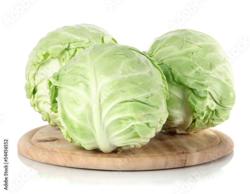 Photo: Cabbage on board for cutting isolated on white Cabbage on board for cutting isolated on white