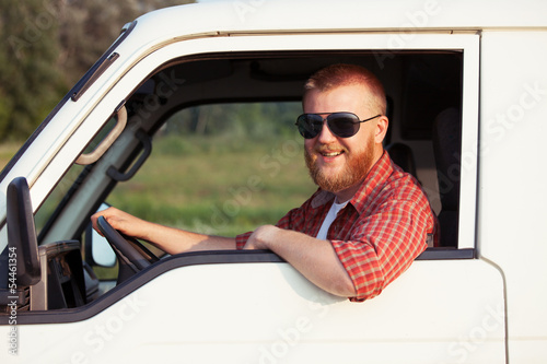Photo: Driver of a small pickup truck Driver of a small pickup truck