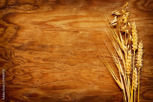 Photo: Different types of cereals displayed on vintage wood background Different types of cereals displayed on vintage wood background