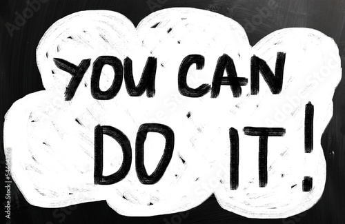 Photo: "You can do it" handwritten with white chalk on a blackboard "You can do it" handwritten with white chalk on a blackboard