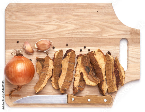 Photo: Dried Cepes. Ingredients for cooking on wood board. Dried Cepes. Ingredients for cooking on wood board.