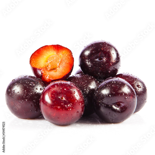Photo: Red plum fruit isolated on white background. Fresh ripe washed Red plum fruit isolated on white background. Fresh ripe washed