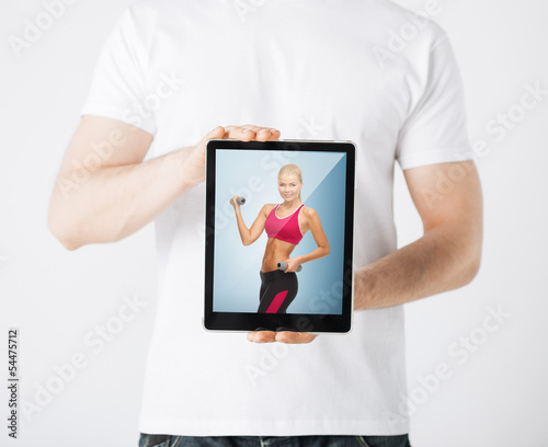 Photo: man with tablet pc and sporty woman man with tablet pc and sporty woman