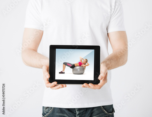 Photo: man with tablet pc and sporty woman man with tablet pc and sporty woman
