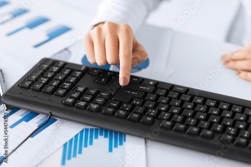 Photo: woman hand pressing enter button on keyboard woman hand pressing enter button on keyboard
