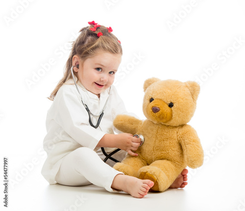Photo: kid girl with clothes of doctor playing with toy kid girl with clothes of doctor playing with toy
