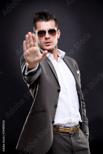 Photo: serious business man showing stop gesture serious business man showing stop gesture