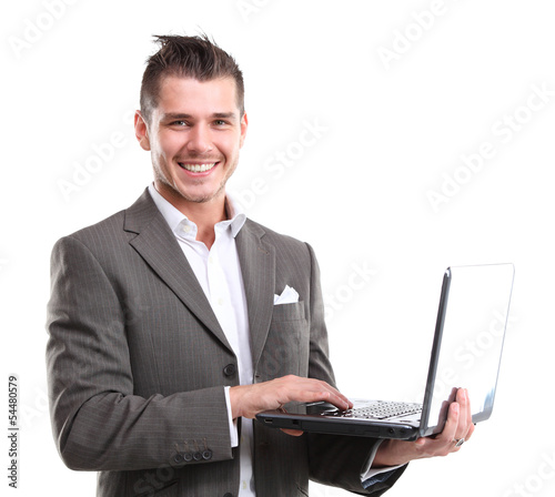 Photo: Business man with a laptop - isolated over a white background Business man with a laptop - isolated over a white background