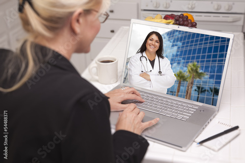 Photo: Woman Using Laptop - Online with Nurse or Doctor Woman Using Laptop - Online with Nurse or Doctor