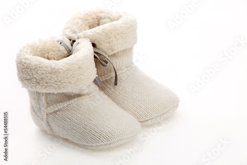 Photo: Pair of baby booties over white Pair of baby booties over white